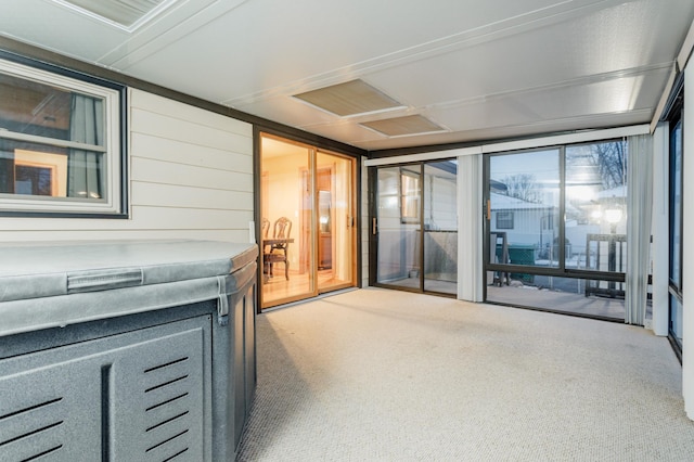 property entrance featuring a patio and a hot tub