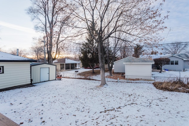 snowy yard with a shed