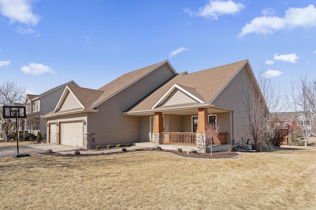 view of front facade with a garage, a front yard, covered porch, and concrete driveway