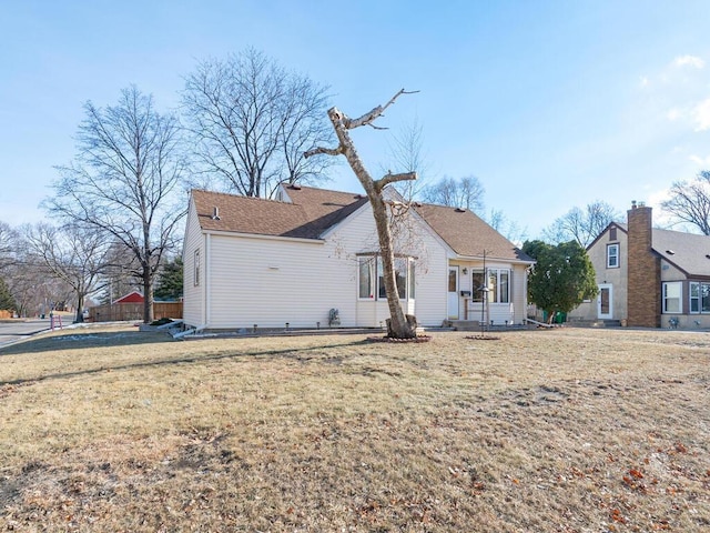 rear view of house featuring a yard