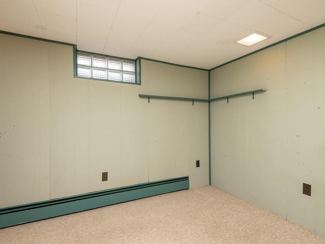 basement featuring baseboard heating and light carpet