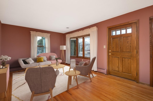 living room featuring light wood-type flooring and baseboard heating