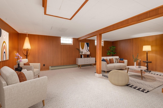 living room with a baseboard radiator, carpet flooring, and wooden walls