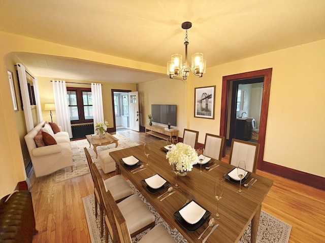 dining room featuring light hardwood / wood-style floors and a notable chandelier