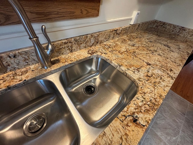 room details featuring sink and stone counters