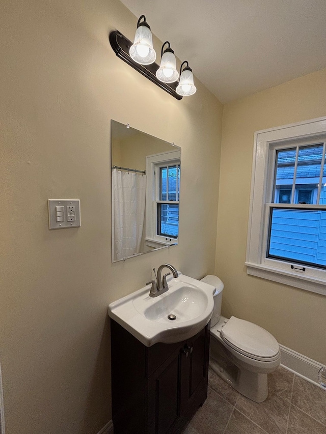 bathroom featuring tile patterned floors, toilet, and vanity