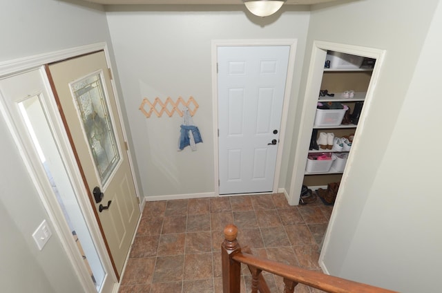 interior space with baseboards and stone finish floor