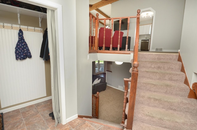 staircase with baseboards and visible vents