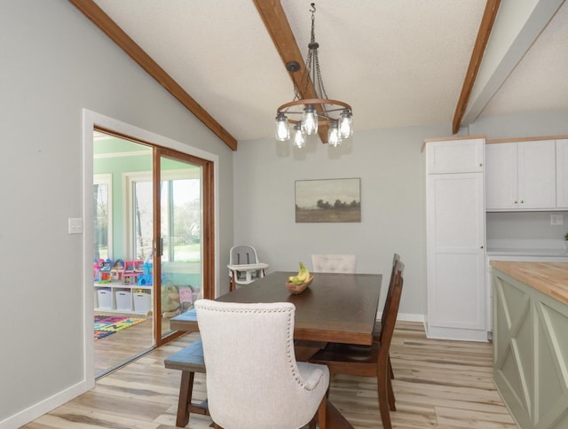 dining room featuring baseboards, vaulted ceiling with beams, and light wood finished floors