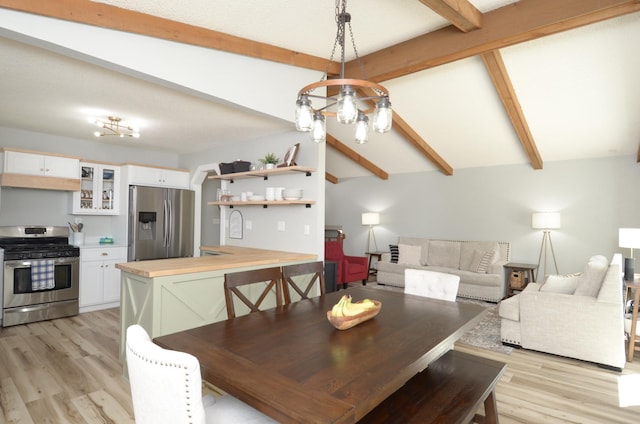 dining space with vaulted ceiling with beams and light wood-style floors