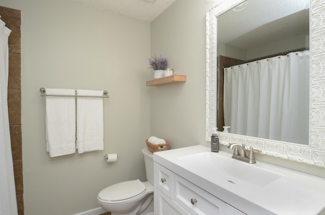 bathroom featuring toilet, a textured ceiling, a shower with curtain, and vanity