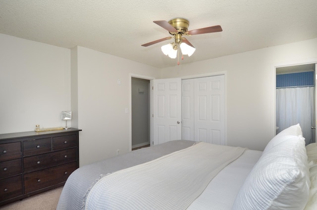 bedroom with a ceiling fan, a closet, and light colored carpet