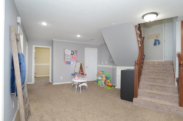 game room with recessed lighting, a textured ceiling, baseboards, and carpet