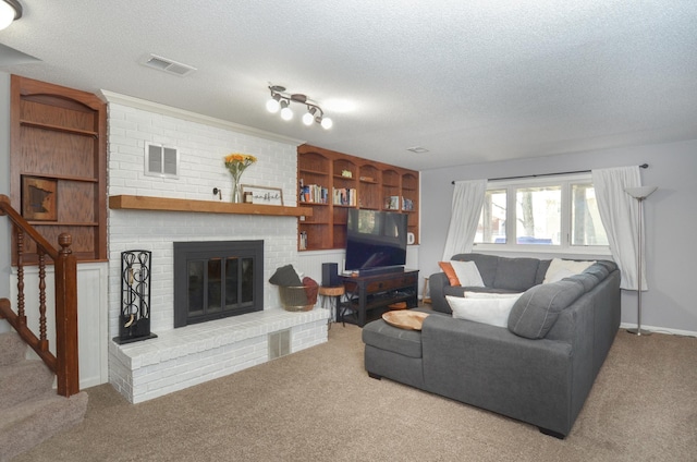 carpeted living area featuring a brick fireplace, a textured ceiling, and visible vents