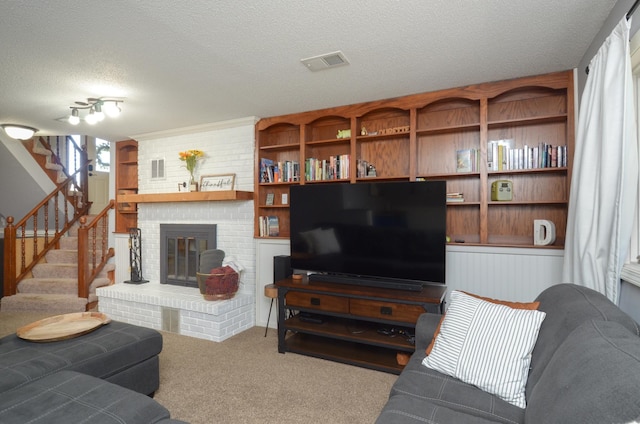 living room featuring visible vents, carpet floors, a fireplace, stairway, and a textured ceiling