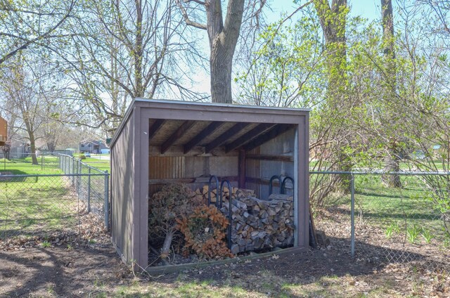 view of outbuilding with fence and an outdoor structure
