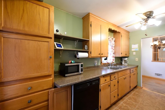 kitchen with sink, ceiling fan with notable chandelier, light tile patterned floors, and black dishwasher