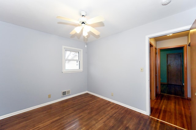 unfurnished room with ceiling fan and dark hardwood / wood-style flooring