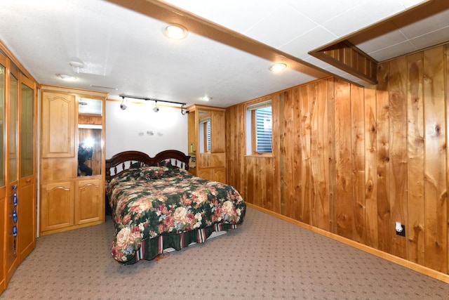 bedroom featuring light carpet and wooden walls