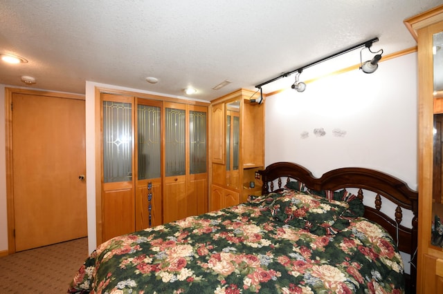 carpeted bedroom with a textured ceiling