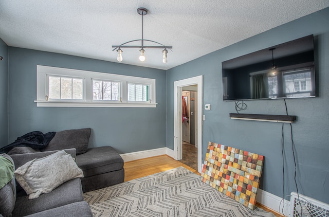 living room featuring light hardwood / wood-style floors and a textured ceiling