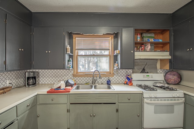 kitchen with sink, decorative backsplash, a textured ceiling, and gas range gas stove