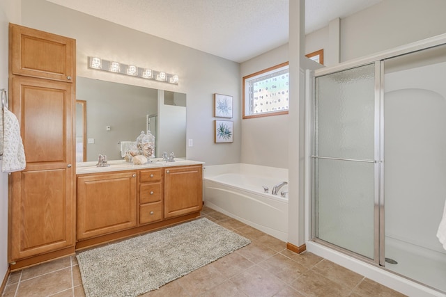 bathroom with vanity, a textured ceiling, and separate shower and tub