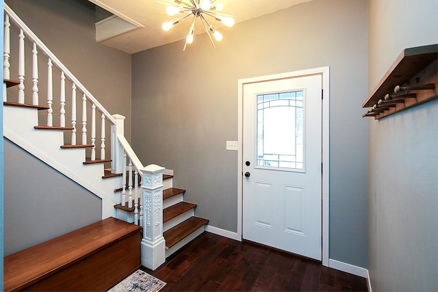 entrance foyer with dark hardwood / wood-style floors and a chandelier