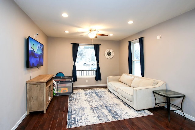 living room with ceiling fan and dark hardwood / wood-style floors