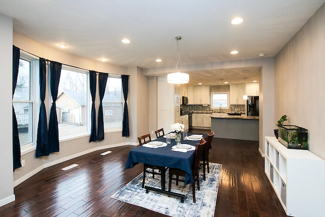 dining space with dark hardwood / wood-style floors