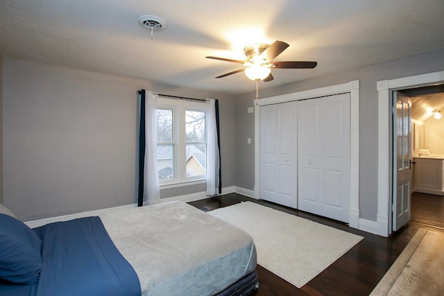 bedroom with ceiling fan, connected bathroom, dark hardwood / wood-style flooring, and a closet