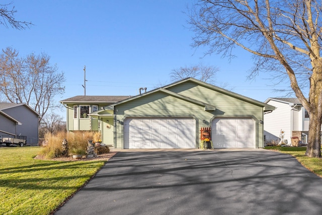 view of front of house with a garage and a front yard