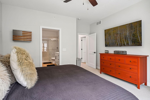 carpeted bedroom with ceiling fan and connected bathroom