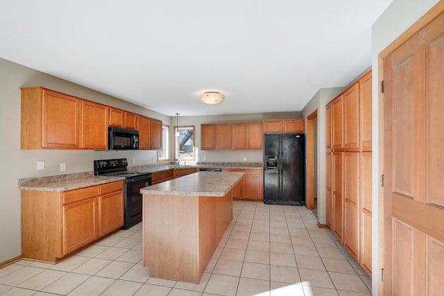 kitchen with light tile patterned flooring, a kitchen island, sink, and black appliances