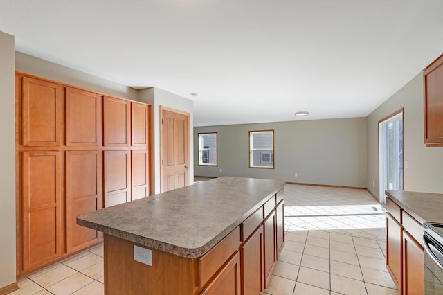 kitchen featuring a wealth of natural light, a center island, and light tile patterned flooring