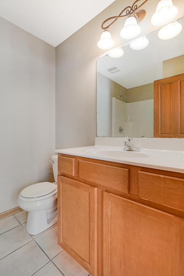 bathroom featuring walk in shower, tile patterned floors, vanity, and toilet