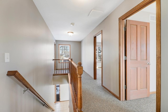 hall featuring light colored carpet