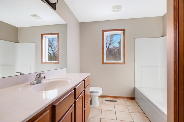 full bathroom featuring vanity, plenty of natural light, tile patterned floors, and toilet