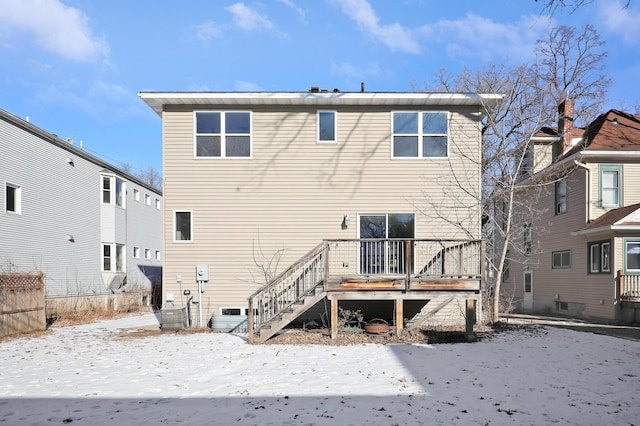 view of snow covered rear of property