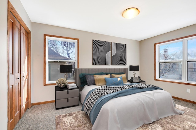 carpeted bedroom with multiple windows and a closet