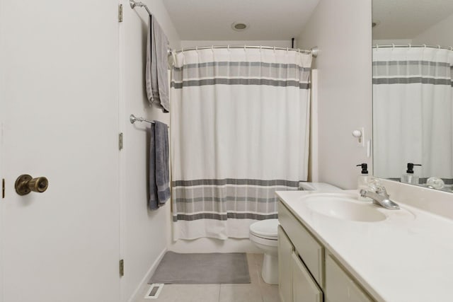 bathroom featuring toilet, a textured ceiling, tile patterned floors, and vanity