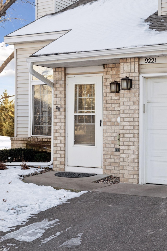 view of snow covered property entrance