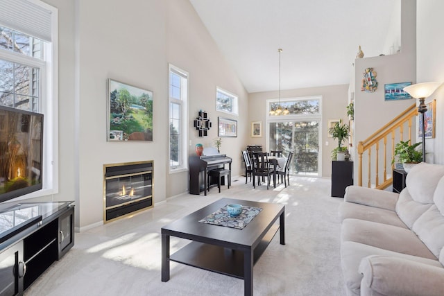 carpeted living room featuring high vaulted ceiling