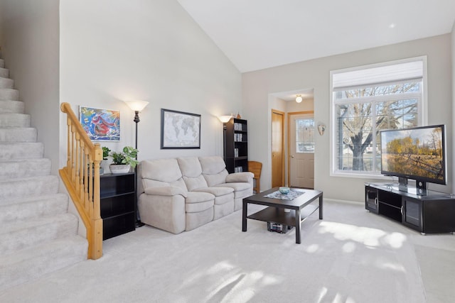 living room featuring carpet floors and vaulted ceiling