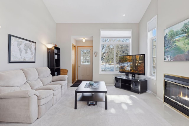 living room with light carpet and vaulted ceiling