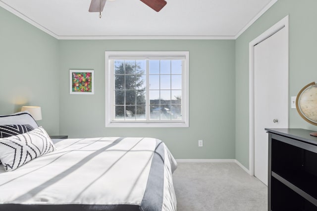 carpeted bedroom with ceiling fan and crown molding