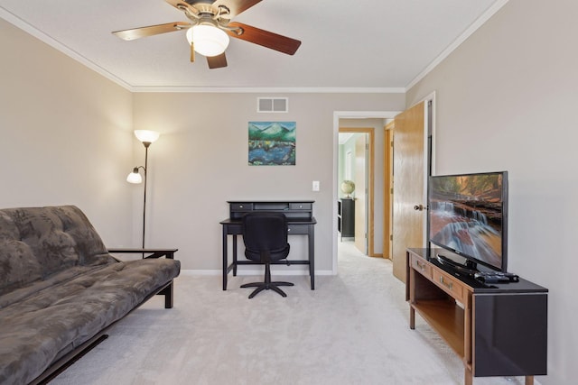 office area with ceiling fan, ornamental molding, and light carpet