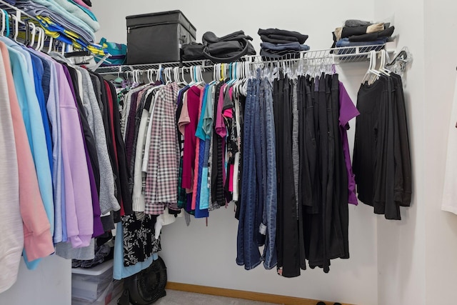 walk in closet with carpet