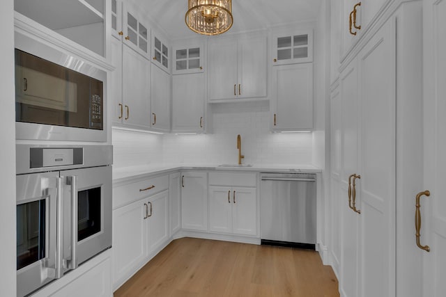 kitchen with sink, white cabinets, and stainless steel appliances