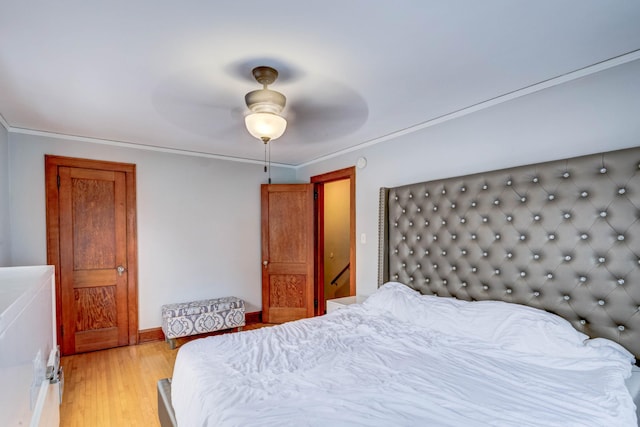 bedroom with ceiling fan, light hardwood / wood-style flooring, and crown molding